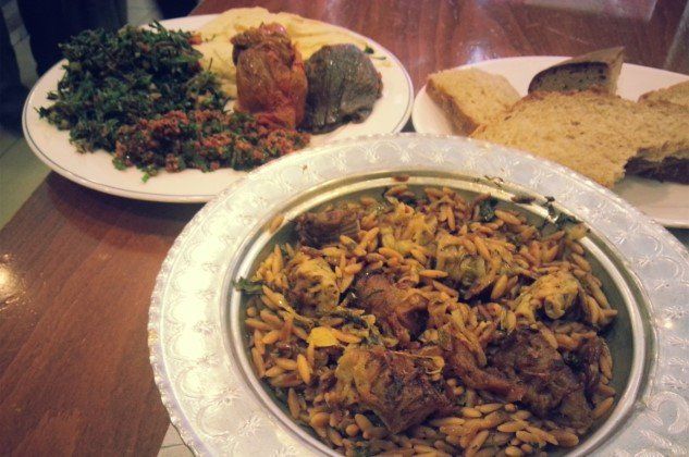 Two plates of food and a bowl of food on a table