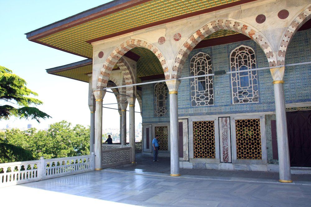 A large building with arches and columns and a balcony