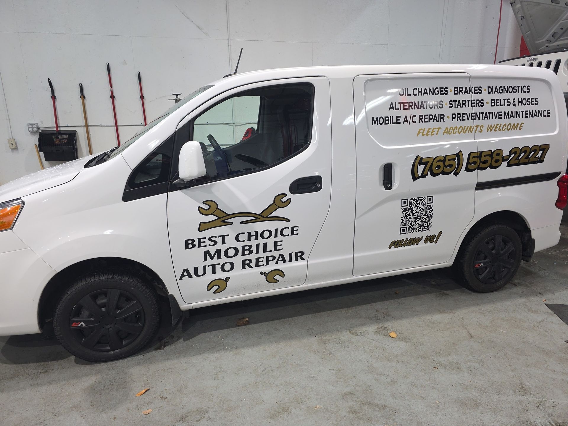 White Best Choice Mobile Auto Repair van with black lettering parked in a garage | Best Choice Service
