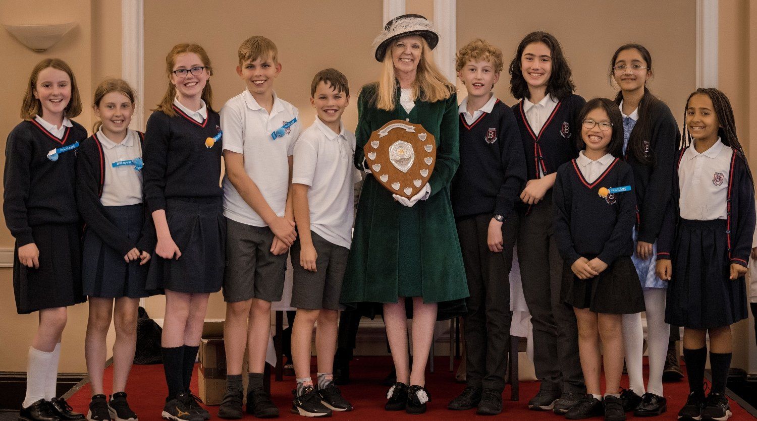 The High Sheriff presenting the award to the 2022 winning team, Bowden Church School