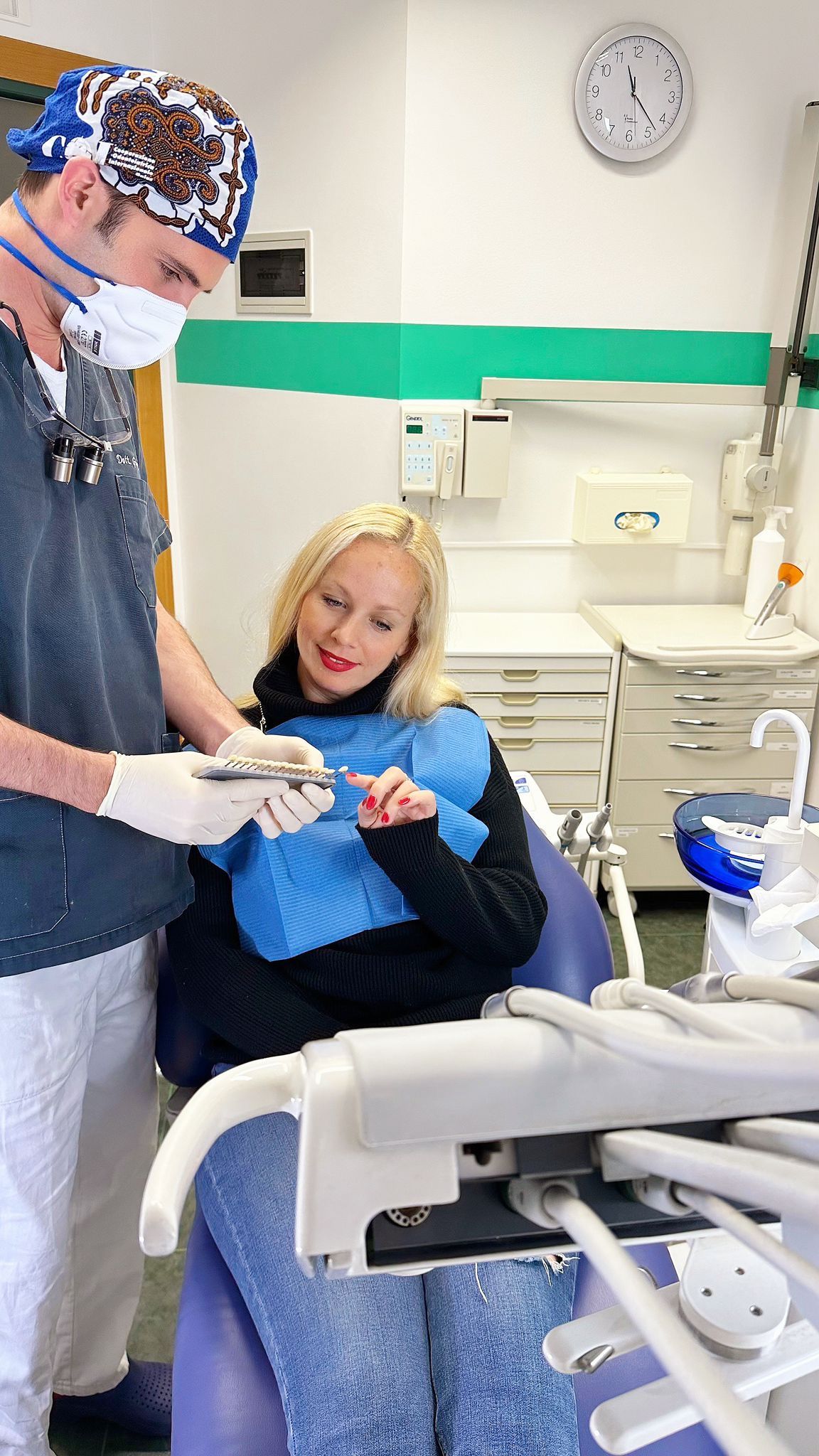 Un dentista visita un paziente sorridente in un luminoso studio dentistico.