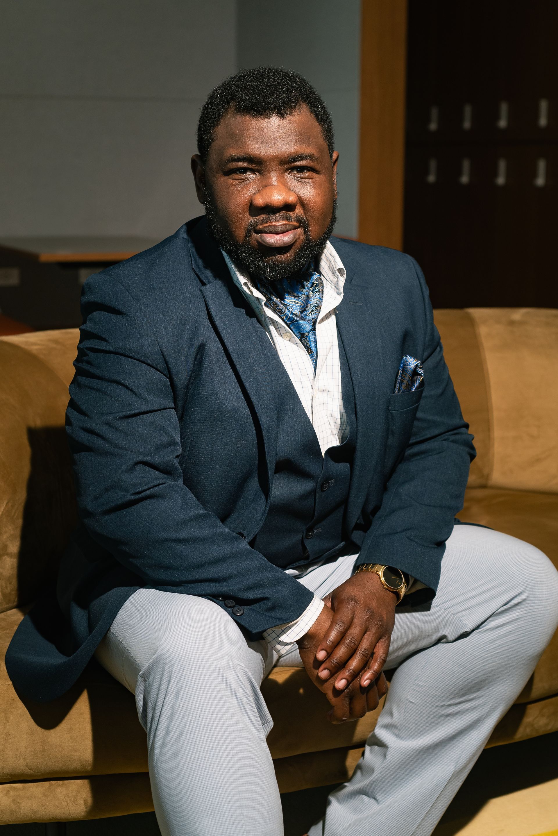 Portrait of Dr. Omotola Ajibade seated on a couch