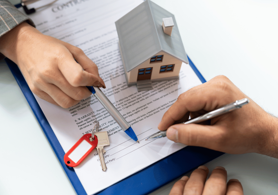 Mobile notary assisting real estate closing with borrower signing documents at home for a smooth tra
