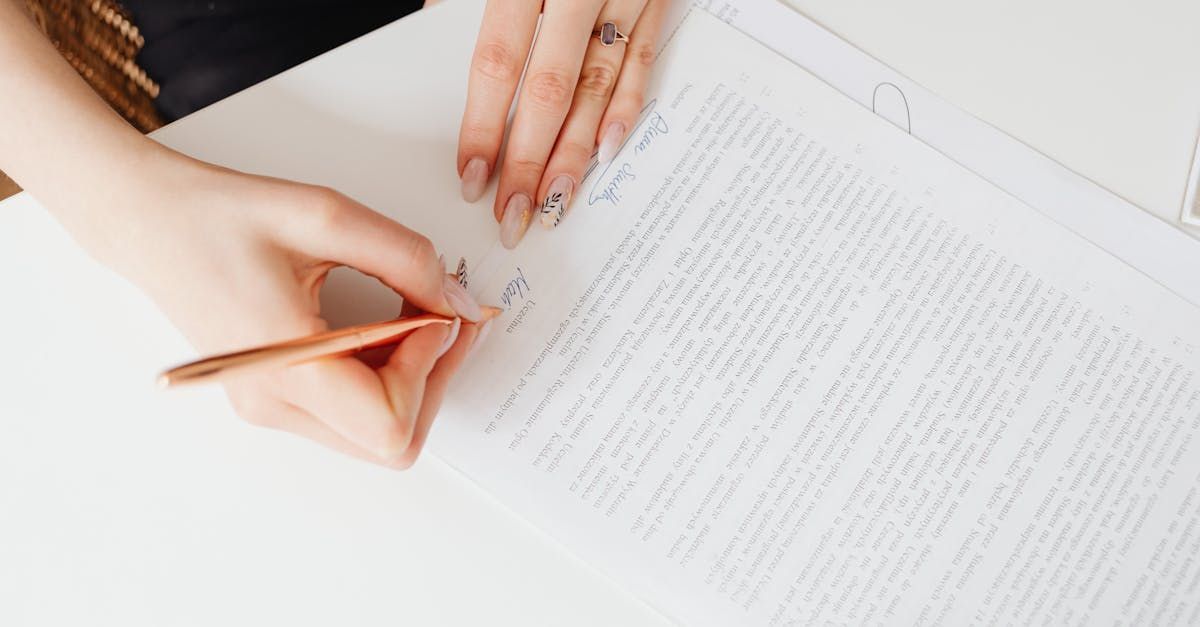 A woman is writing on a piece of paper with a pencil.