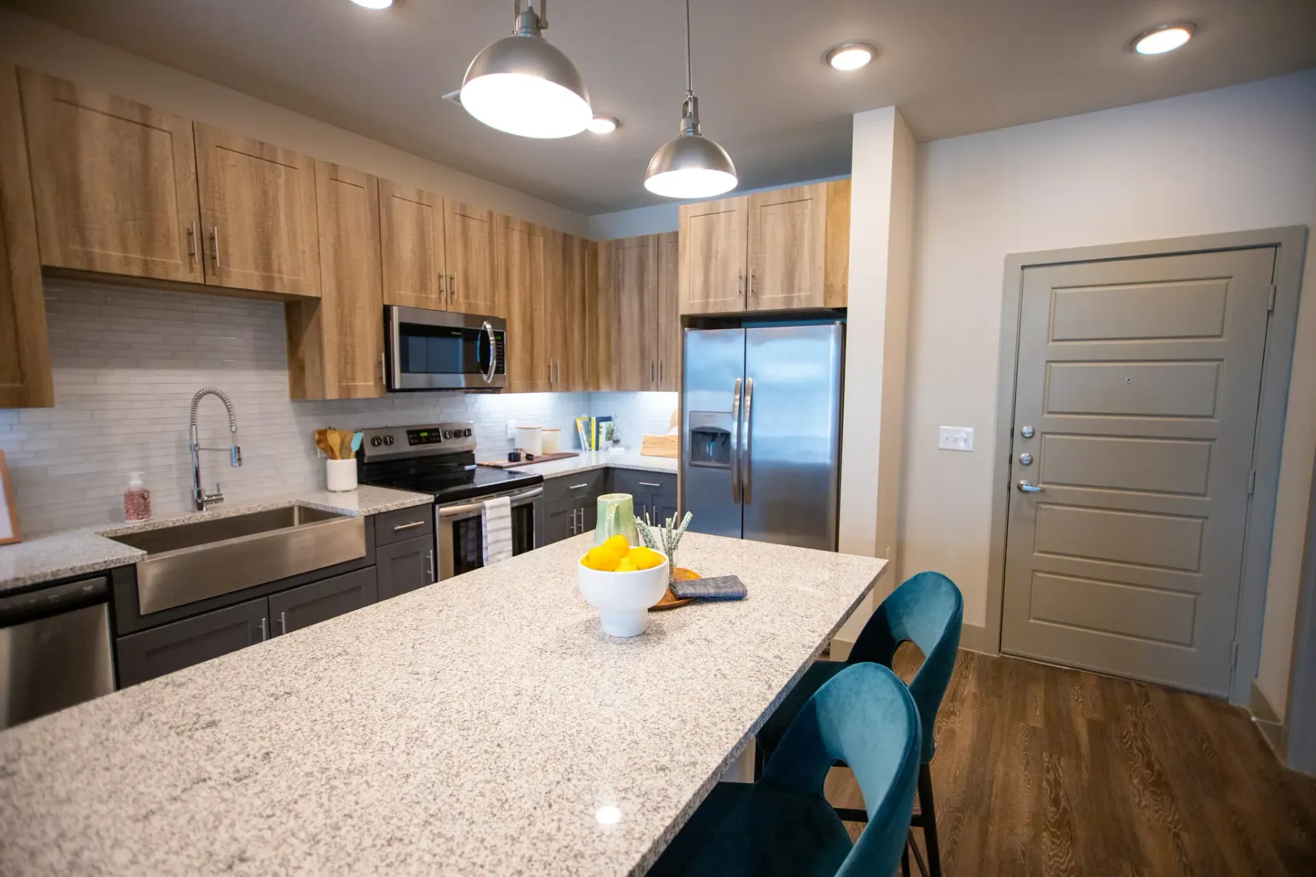 Open-concept kitchen with granite countertops, stainless steel appliances, and an island.
