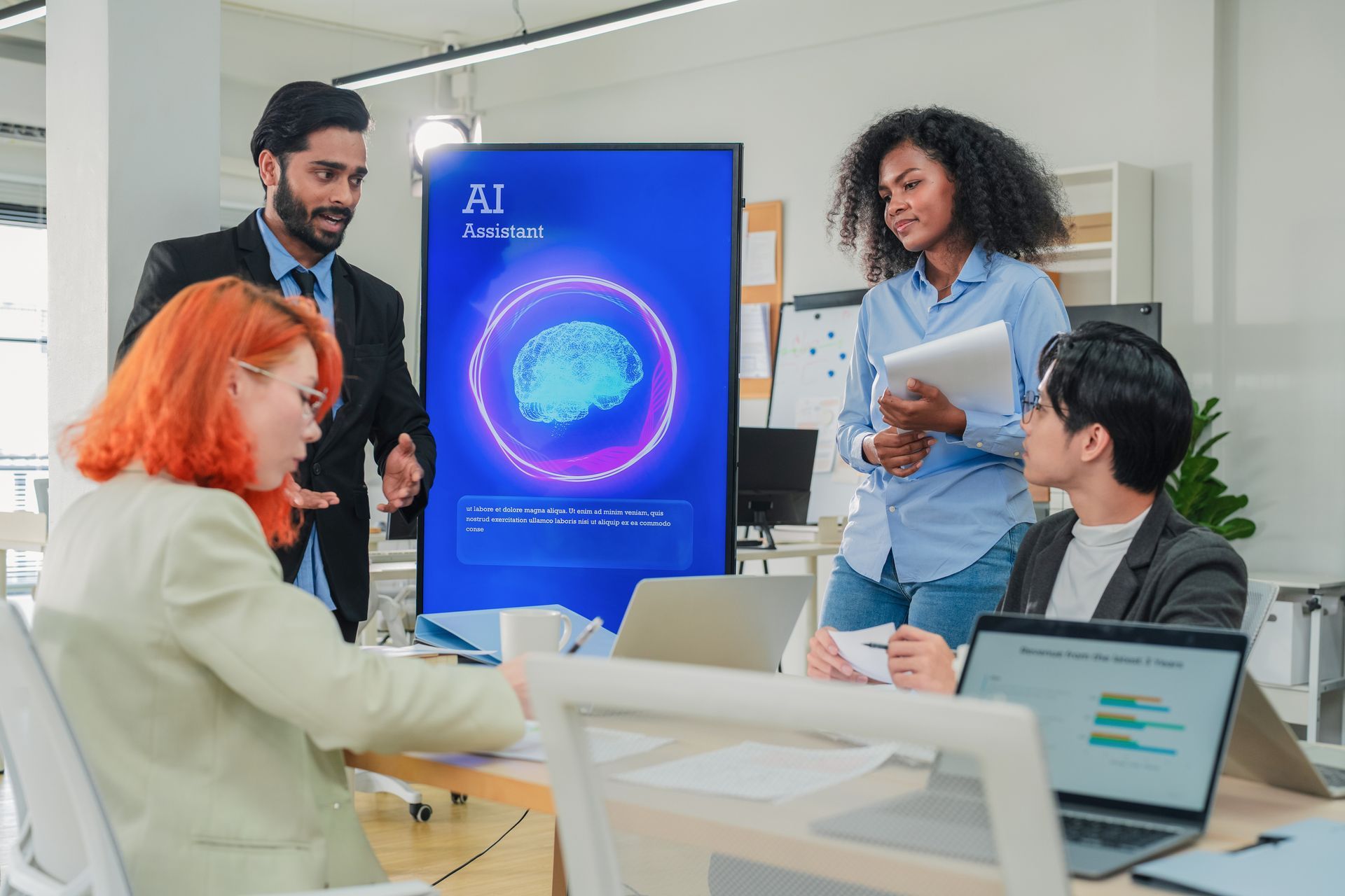 Team meeting around a blue AI presentation screen in a bright office, with laptops and papers on the table.