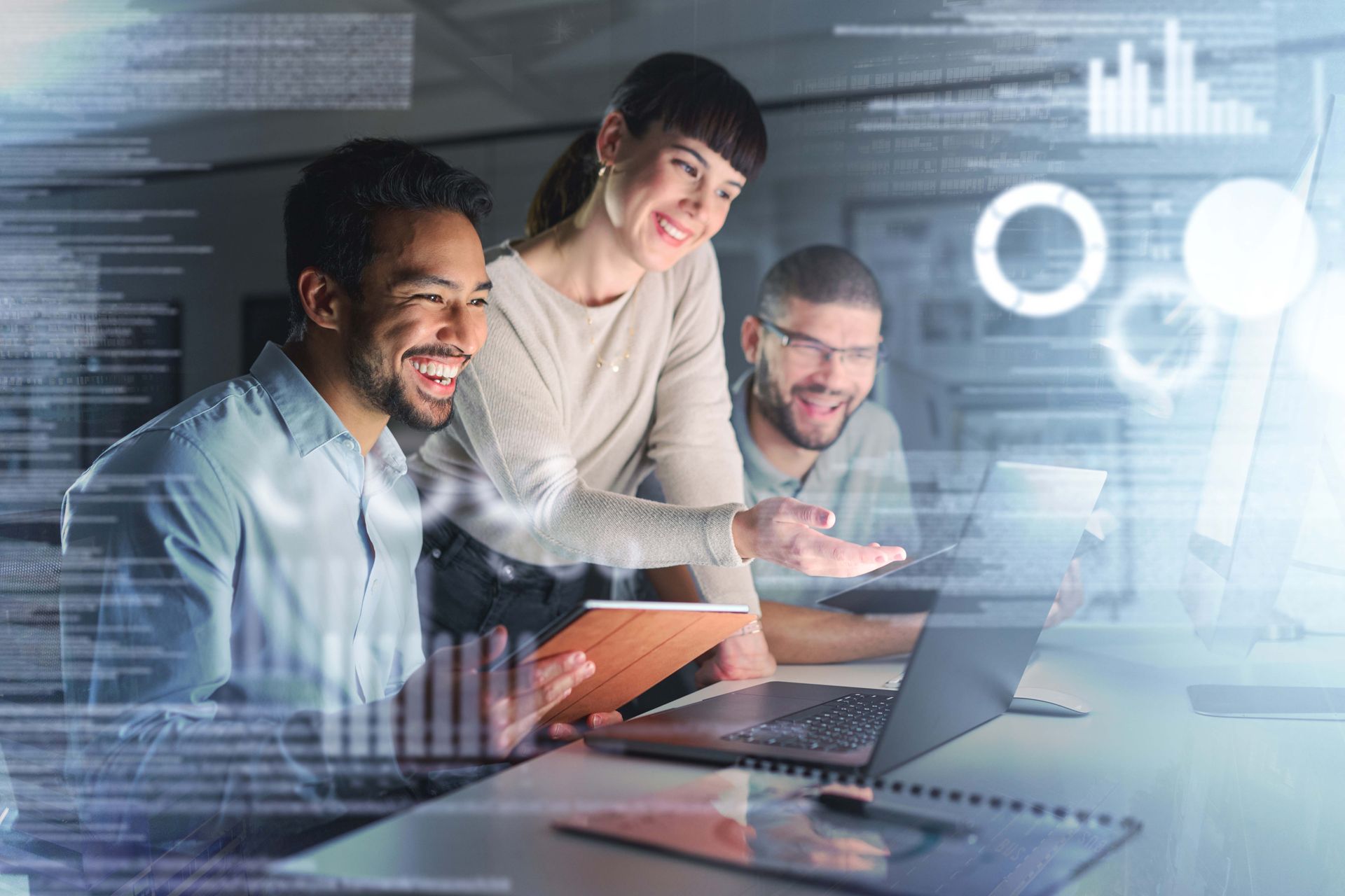 Three coworkers collaborating around a laptop in a modern office with digital data overlays