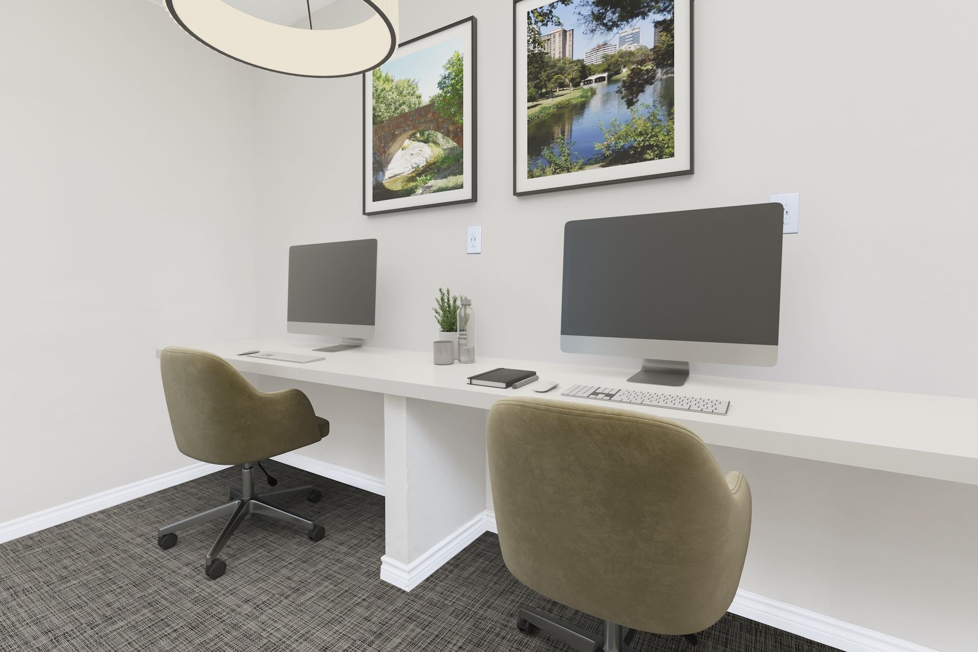 A computer workstation with two monitors, chairs, and decorations, set against a white wall.