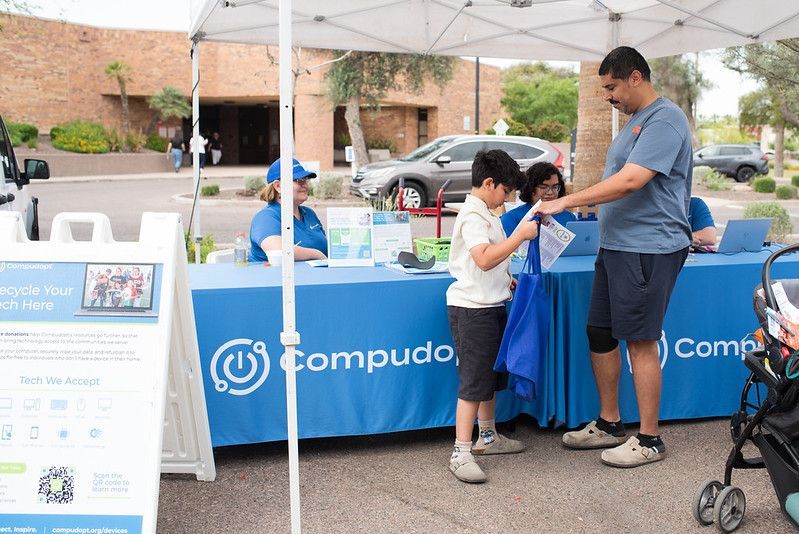A Tempe family picks up their free computer from the Compudopt tent at the 8th Annual Care Fair Temp