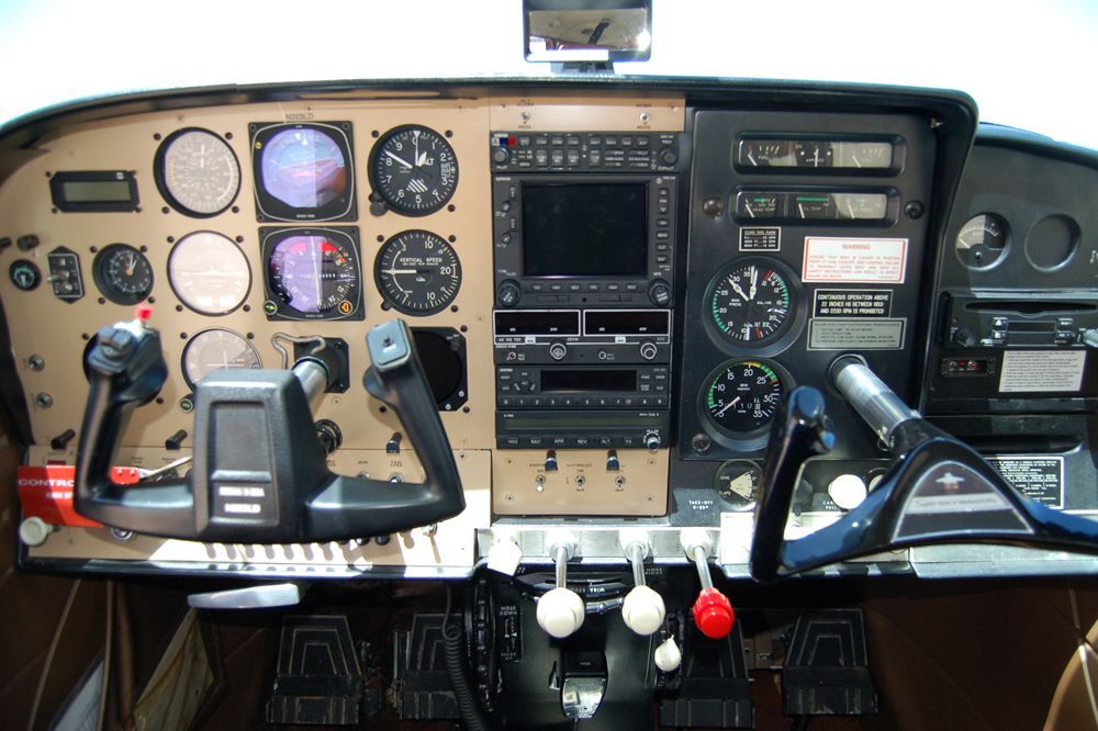 A cockpit of an airplane with many instruments on it