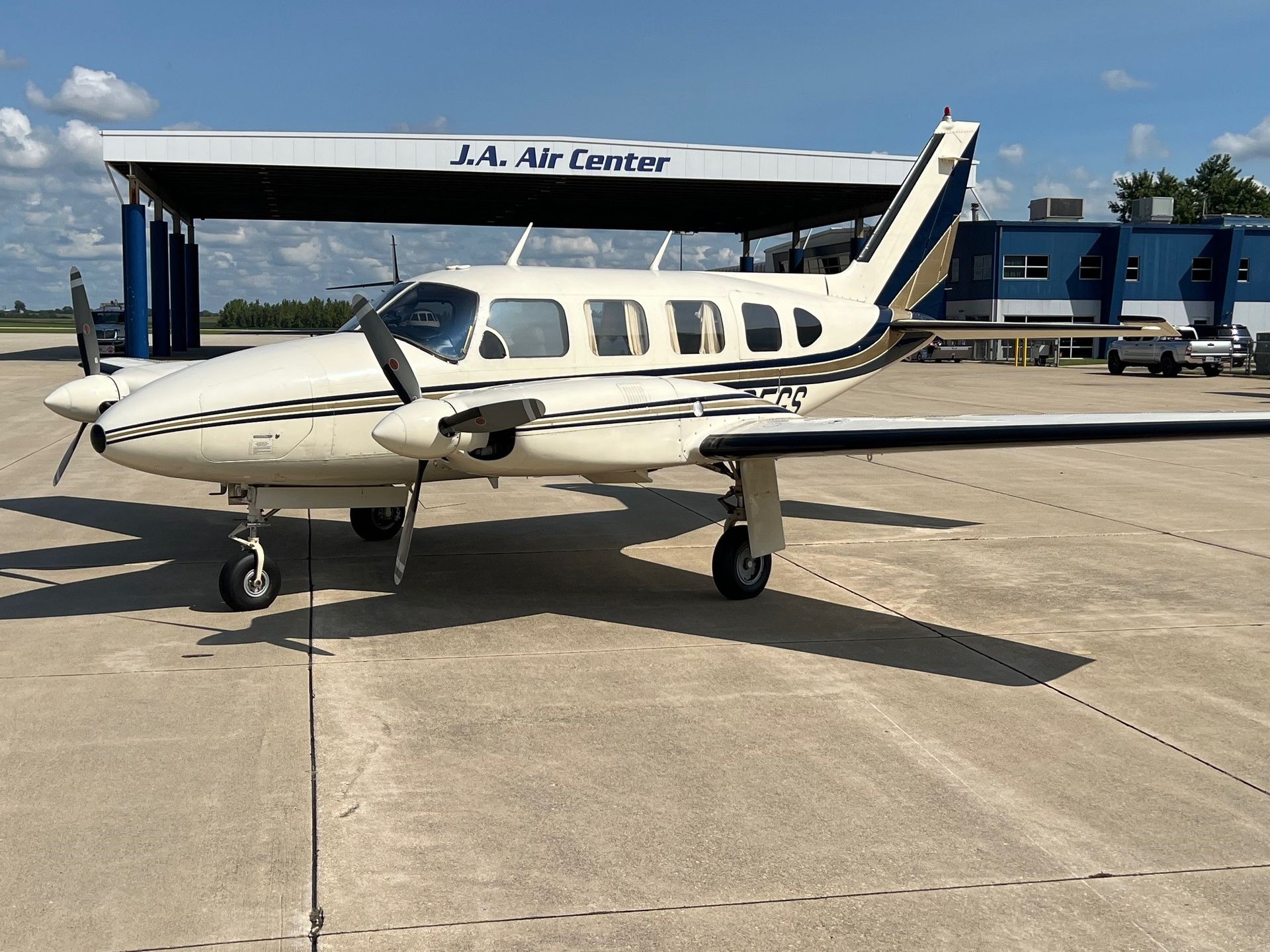 A small plane is parked in front of the la air center