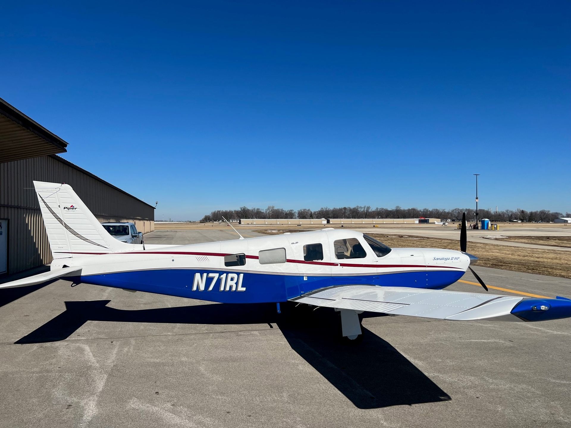 A small blue and white plane with n71rl written on the side