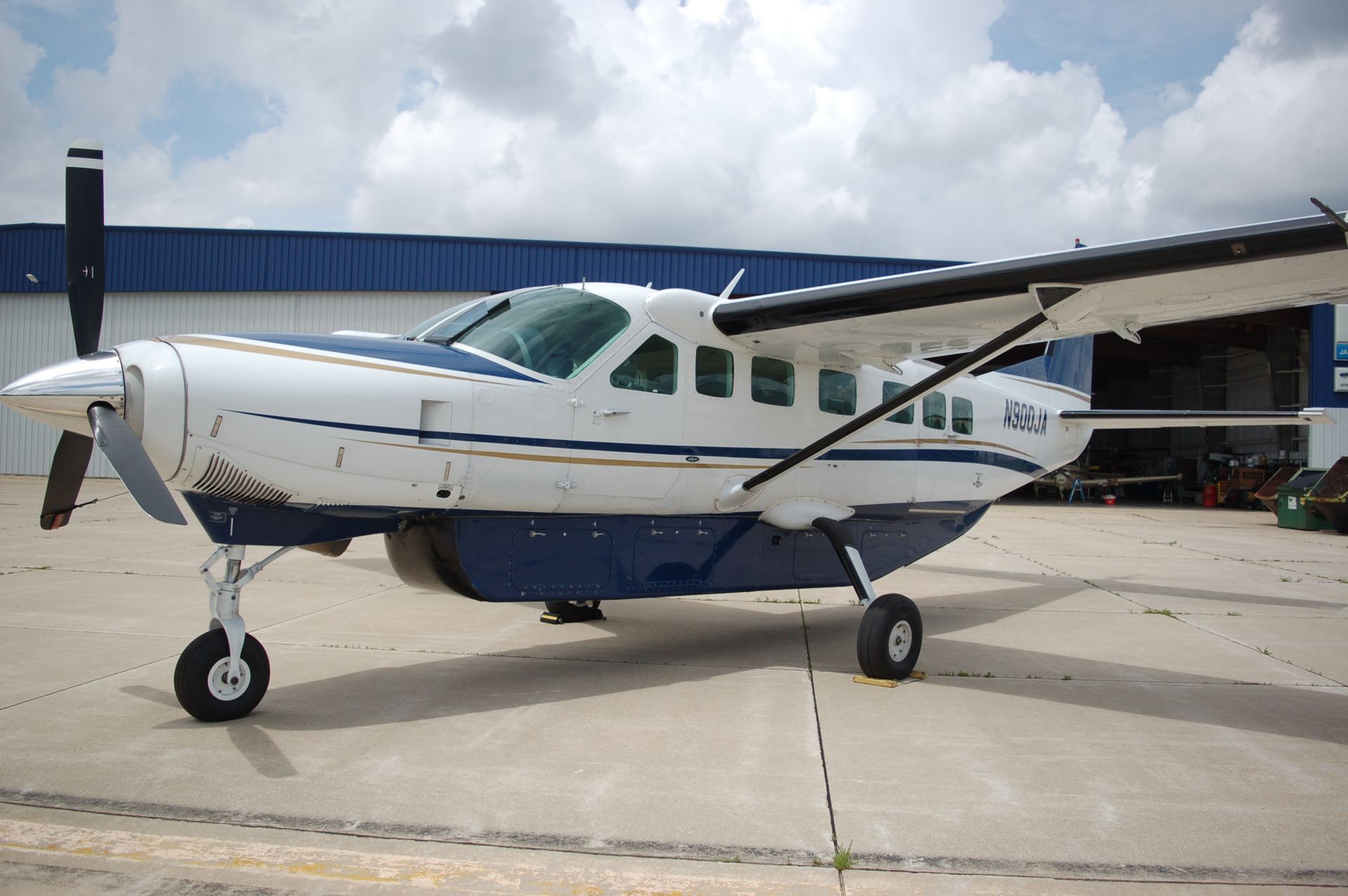 A small blue and white plane with the letters jpn on the side