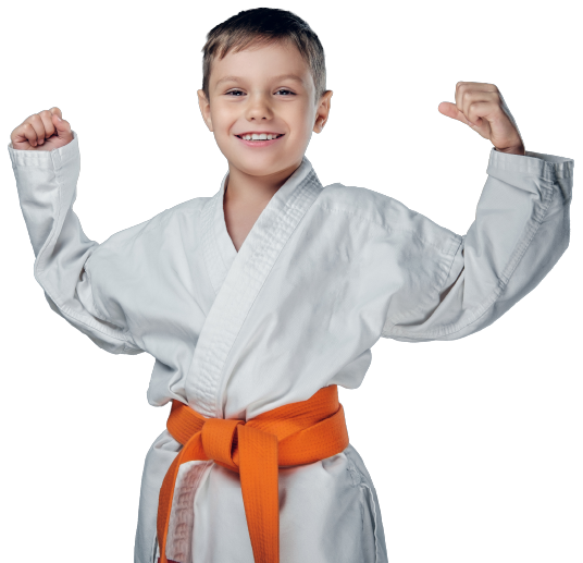A smiling martial artist in a white gi with an orange belt, flexing both arms with fists clenched against a white background.