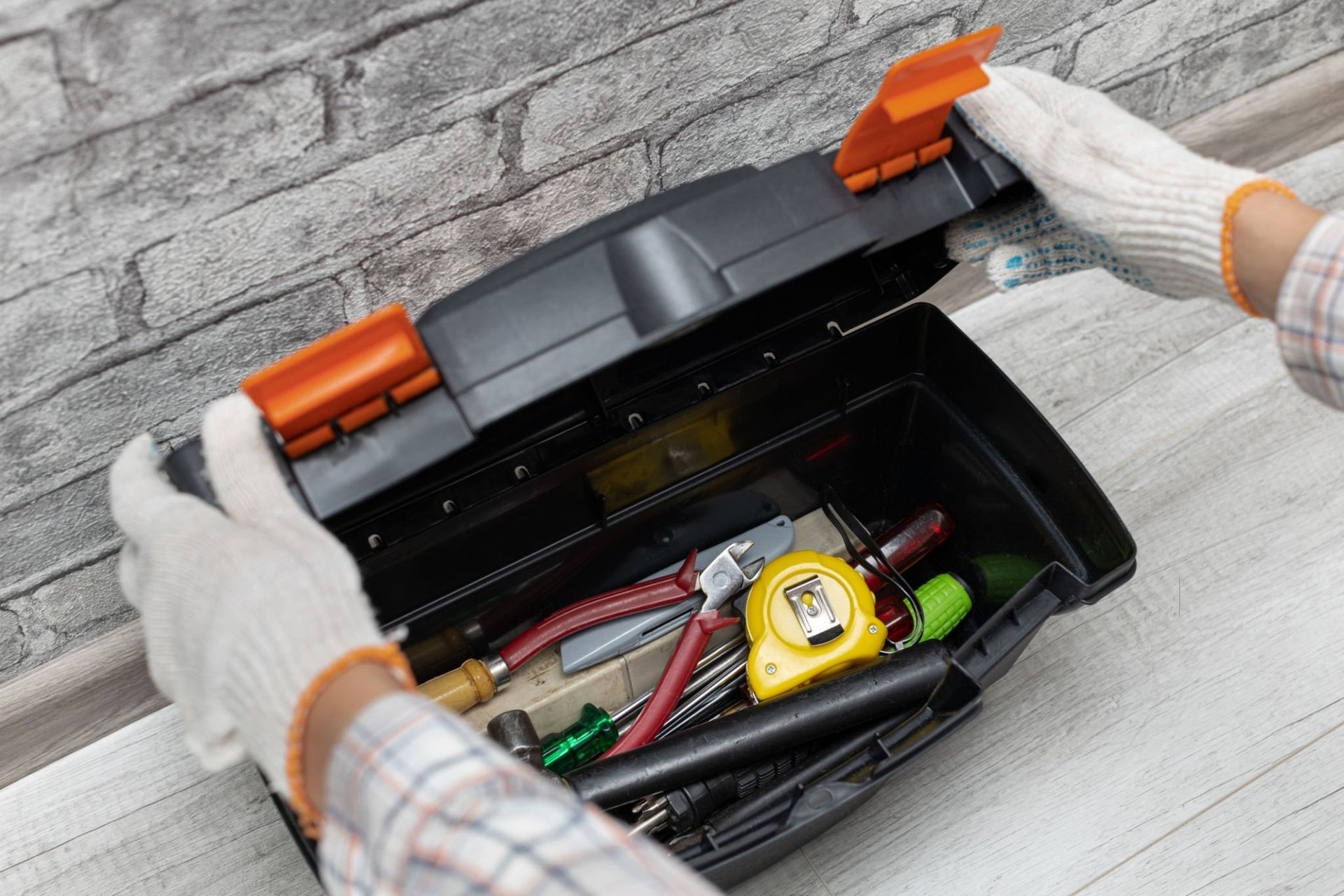 Candudo handyman open his tool box servicing Michigan