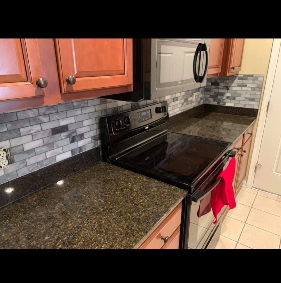 A kitchen with a stove top oven and a microwave