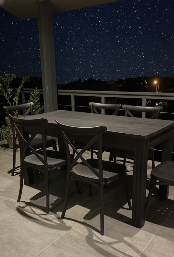 Juego de comedor al aire libre bajo el cielo estrellado.