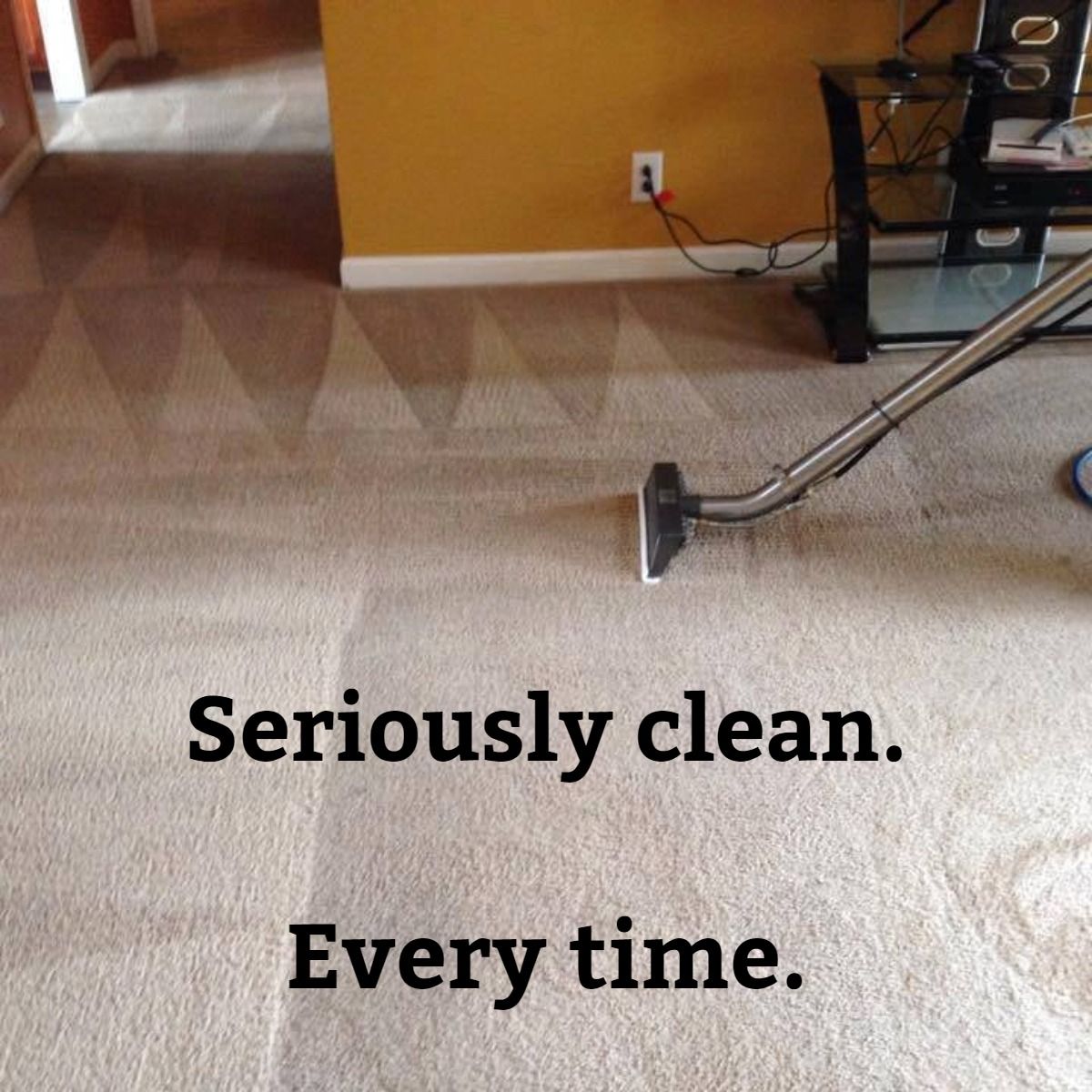 a vacuum cleaner is being used to clean a carpet in a living room