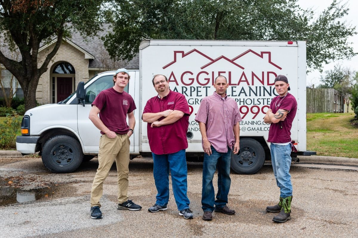 Aggieland Carpet Cleaning team and the service van behind.