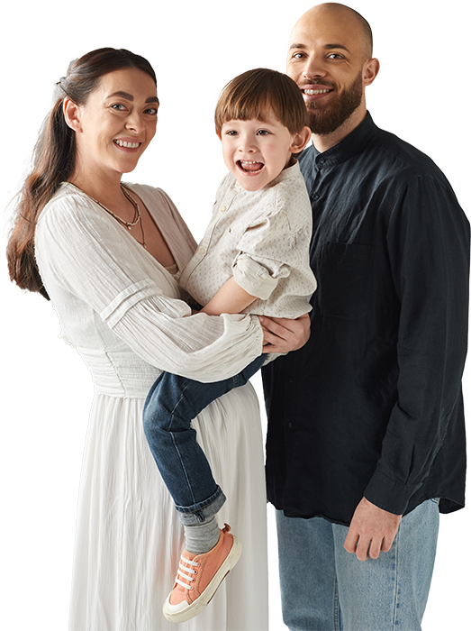 a man and a woman are holding a child in their arms .