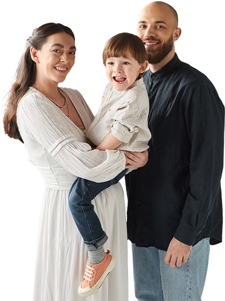 a man and a woman are holding a child in their arms .