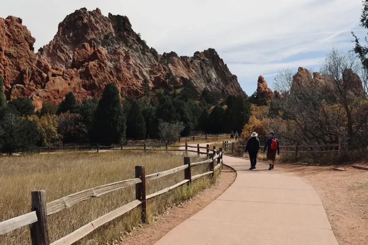 People walking along path in Colorado nature during the fall.