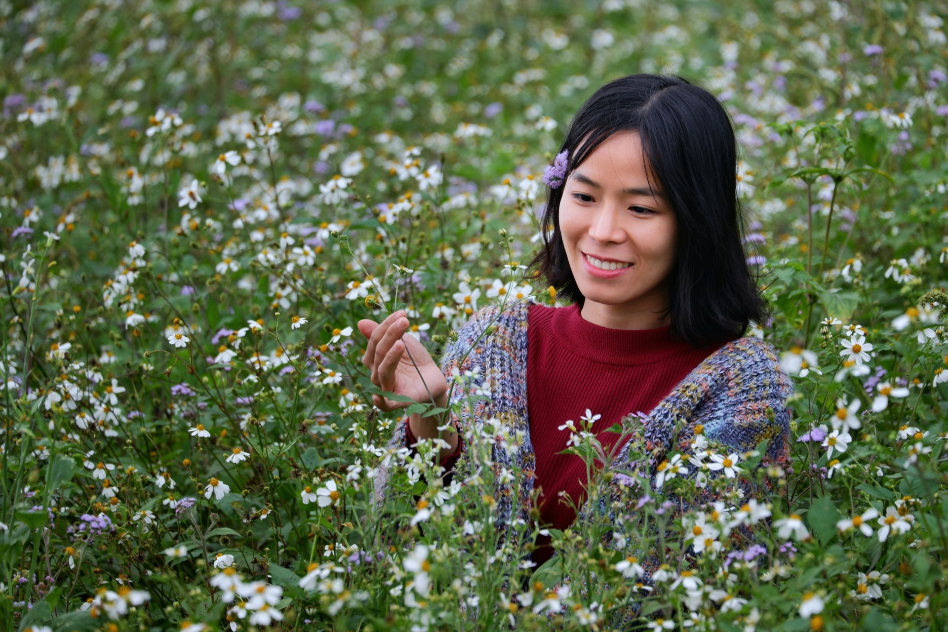 Woman standing in a field of flowers