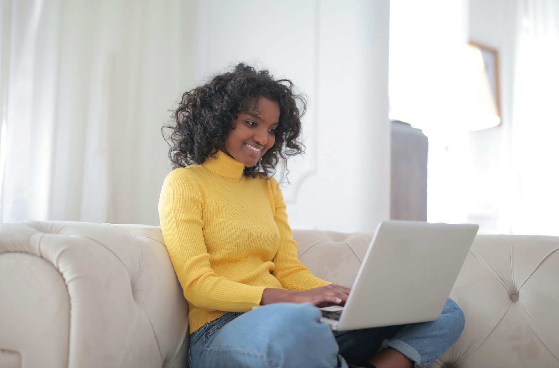 Woman on laptop smiling