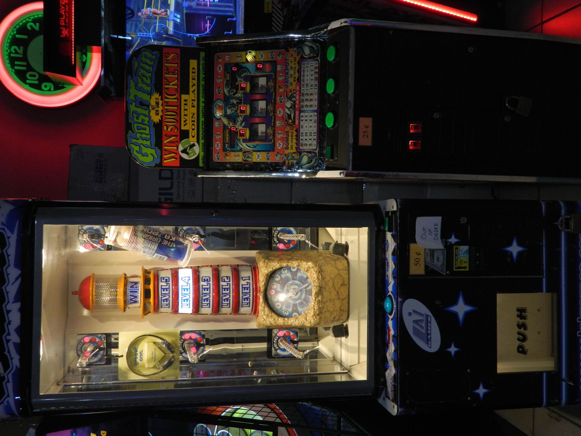 Two arcade machines: a brightly lit, slot machine-themed one, and a darker, space-themed game.
