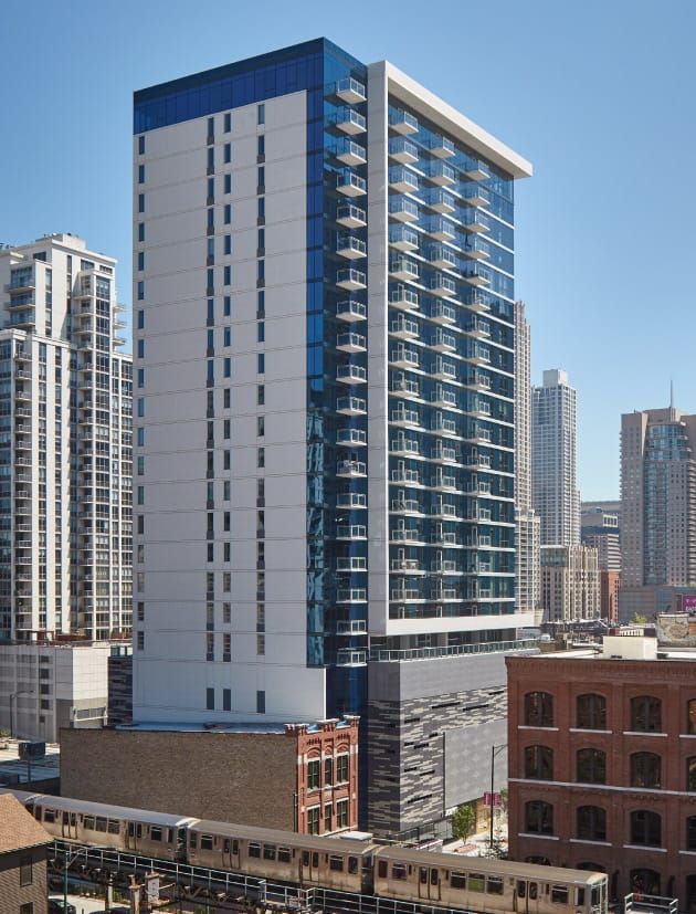 A very tall building with a lot of windows in a city
