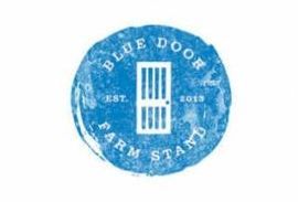 A blue circle with the words blue door farm stand on it