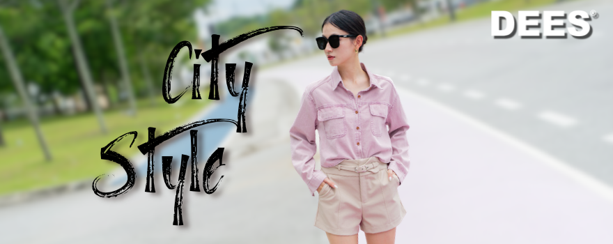 Person in pink shirt and beige shorts standing on a road with “City Style” text.
