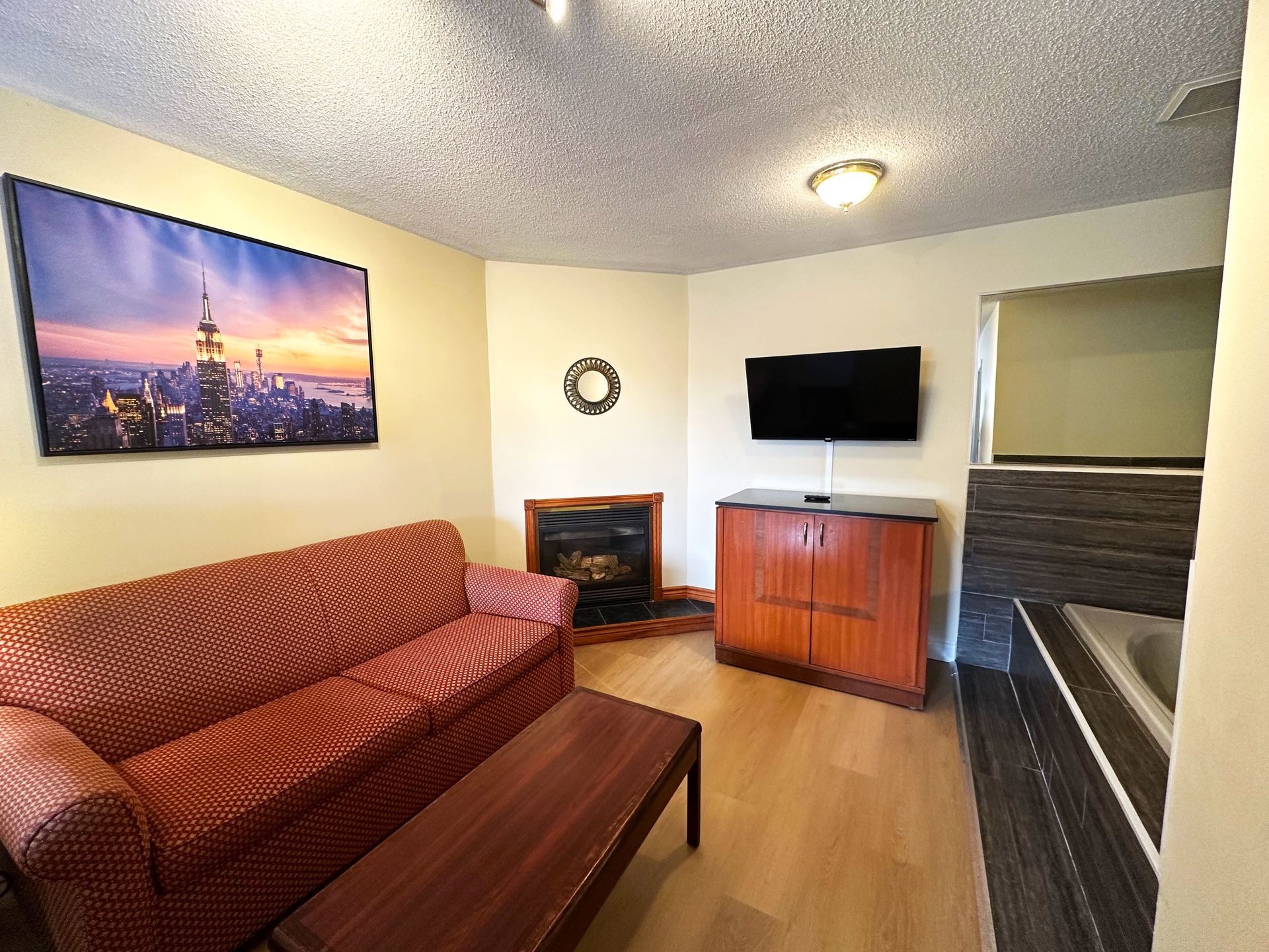 a living room with a couch a fireplace and a flat screen tv
