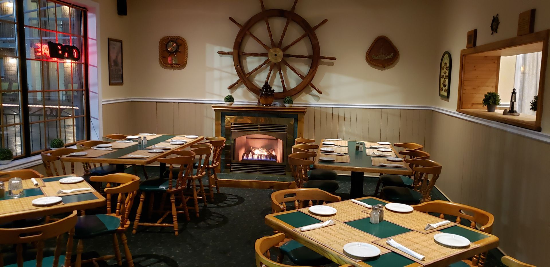 a restaurant with tables and chairs and a fireplace