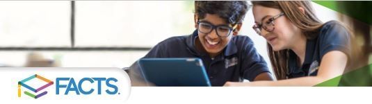 A boy and a girl are looking at a laptop together.