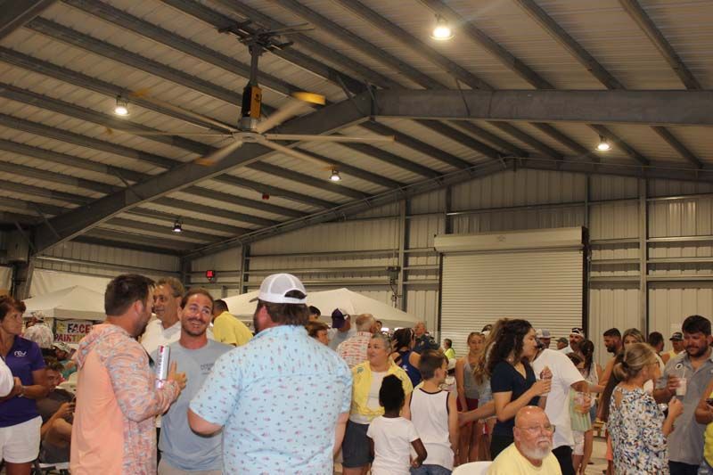 A large group of people are standing in a large building.