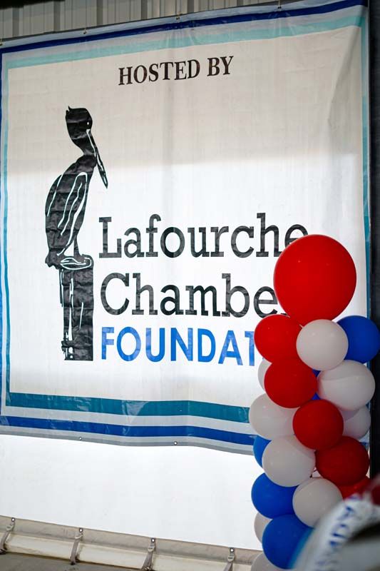 Hosted by Lafourche Chamber Foundation banner with red, white, and blue balloons