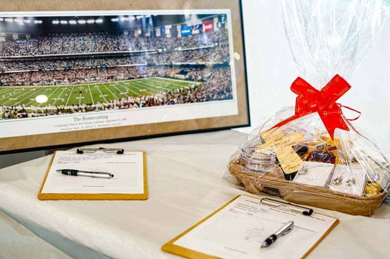 A table with a basket of food and a picture of a football field.