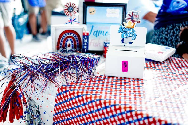 Patriotic party table with red, white, and blue decorations and gift boxes