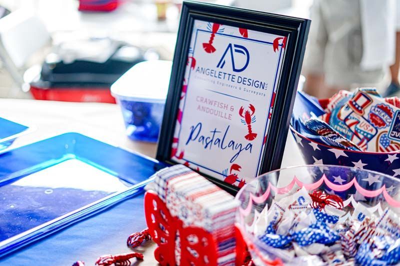 Decorated table with wrapped gifts and a framed certificate at a patriotic-themed celebration