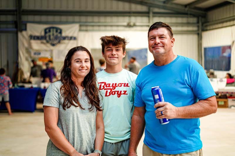 A man and two children are posing for a picture in a building.