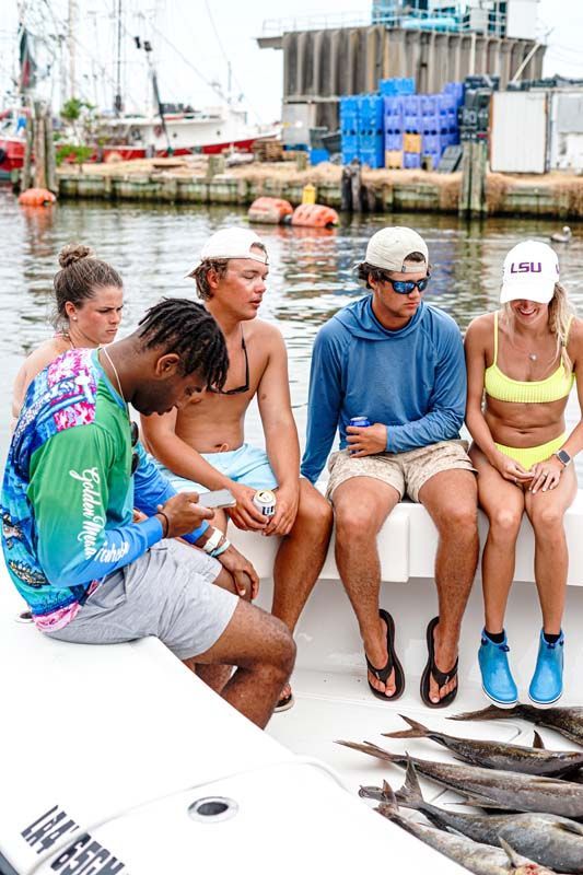 A group of people are sitting on a boat in the water.