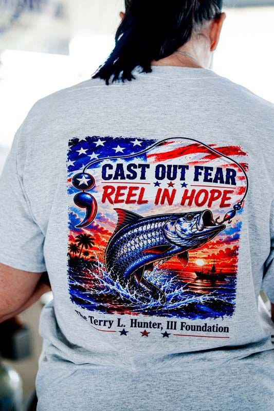 Gray T-shirt with colorful fish graphic and text “Cast Out Fear, Reel in Hope.”