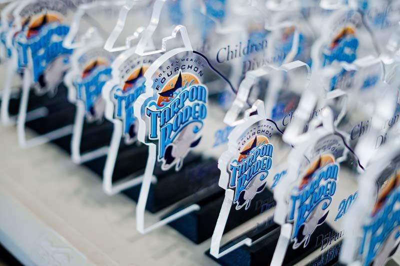 Rows of white TCU Horned Frogs logo cutouts arranged on a table, with blue and purple accents.