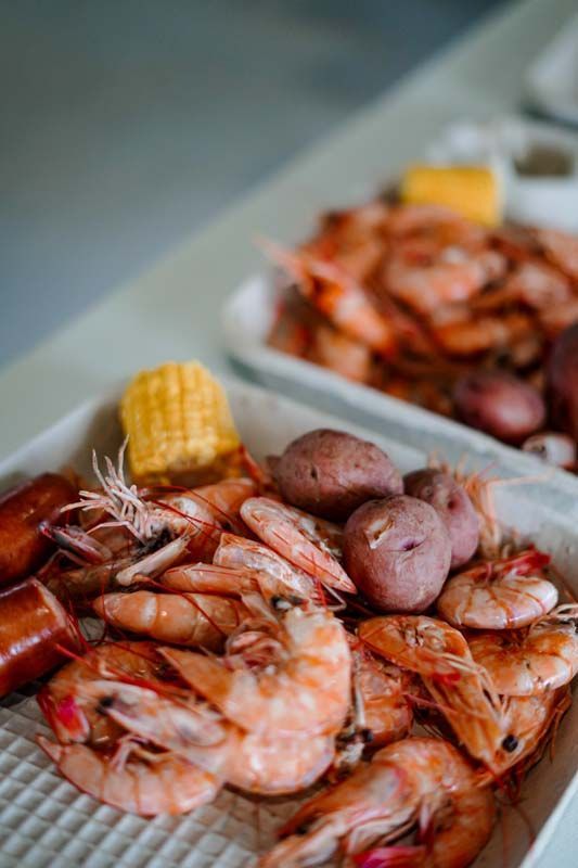 Seafood boil with shrimp, sausage, potatoes, and corn on a tray