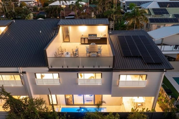 House with rooftop solar panels and pool