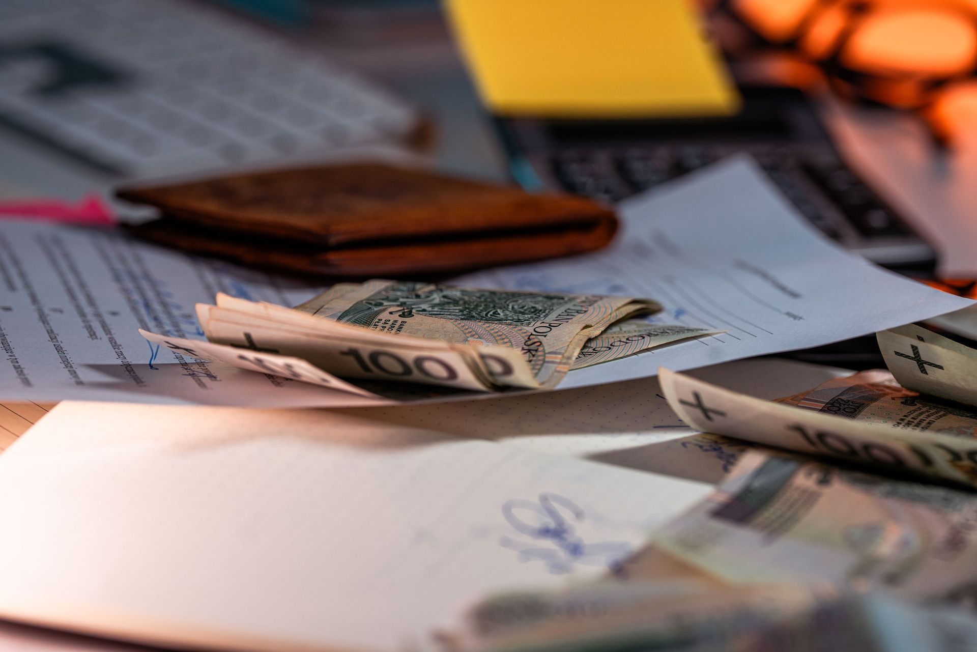 Cash and paperwork on desk for finance planning