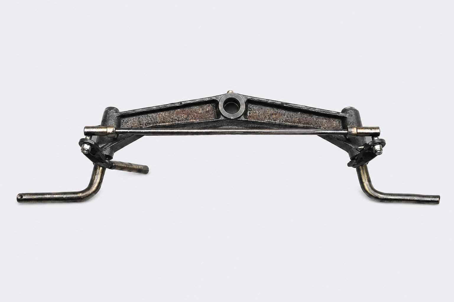 Metal wall-mounted bracket with two side hooks and a central circular opening on a light background