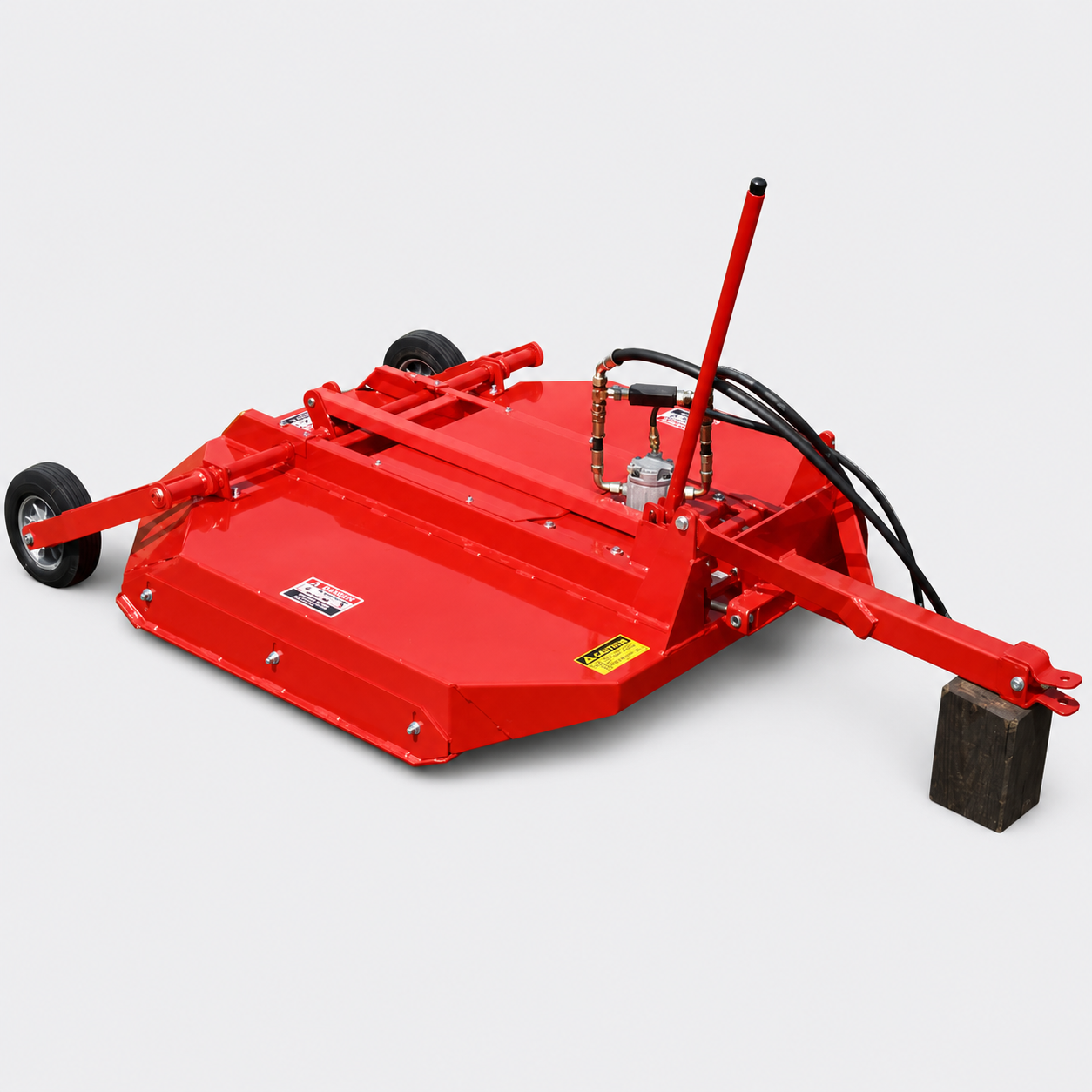 Red tow-behind lawn mower with black wheels and a long handle on a white background