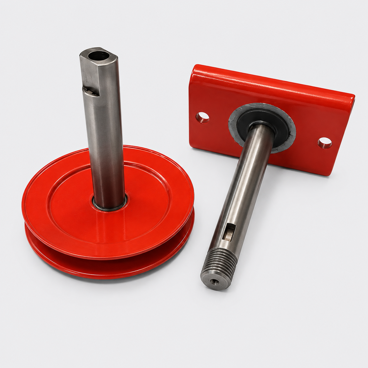 Two red metal brackets with silver shafts and mounting holes on a white background